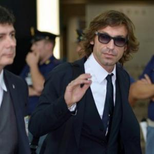 Beaten but unbowed, Italy squad returns home